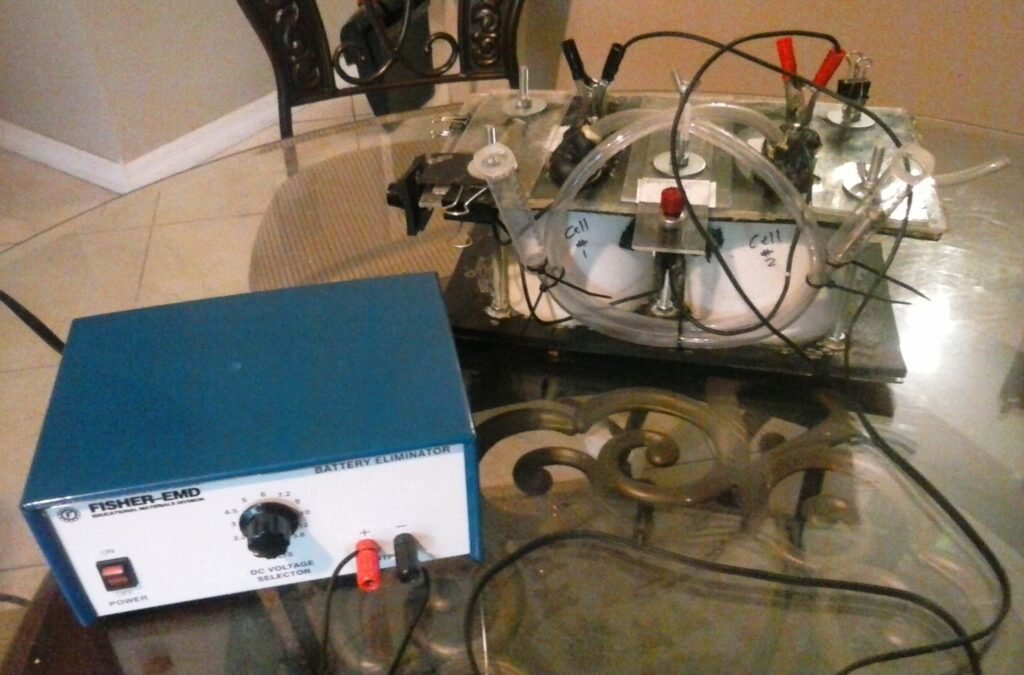 Designed a simple electrolysis fuel cell to illustrate the principle of hydrogen production and its possible implementation in internal combustion applications. Two cells. On/off button. Pipes. Hooked up to power supply. 