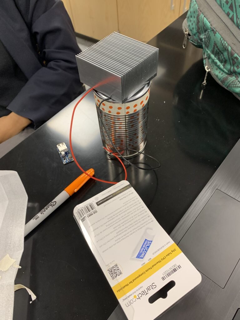 Emergency cell phone charger using a thermoelectric and a can. 