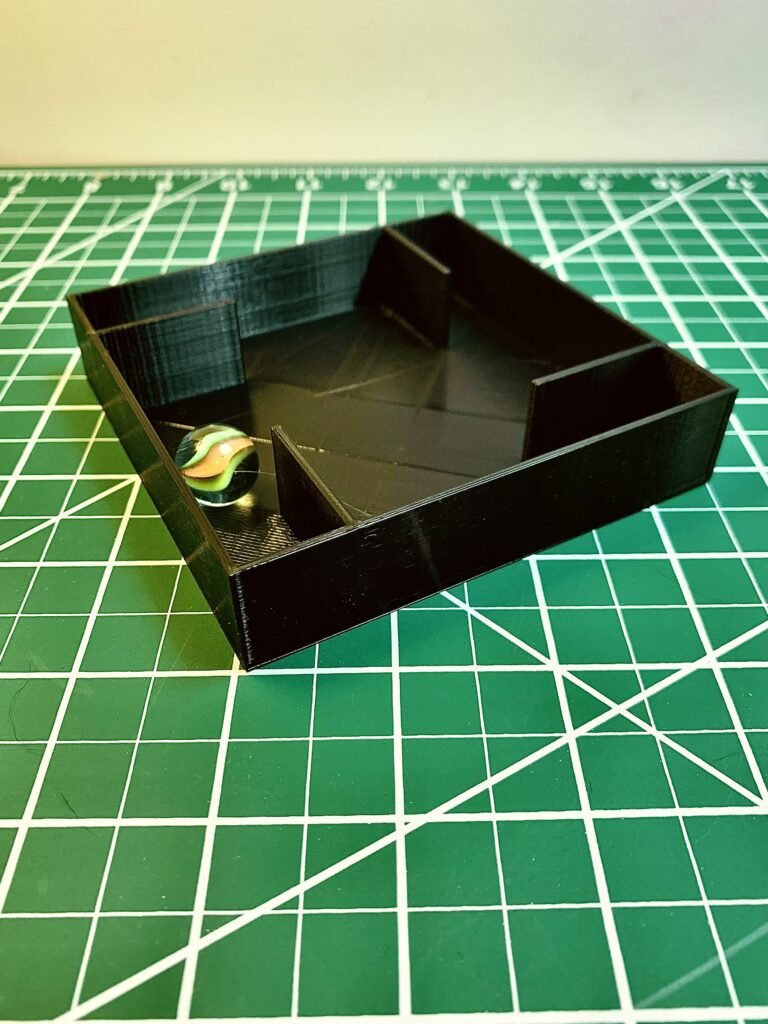 3D Printed Mystery box activity. It's 3D printed rectangular box with different fin designs on the inside and a marble. This one has 4 fins on the corners and one marble.