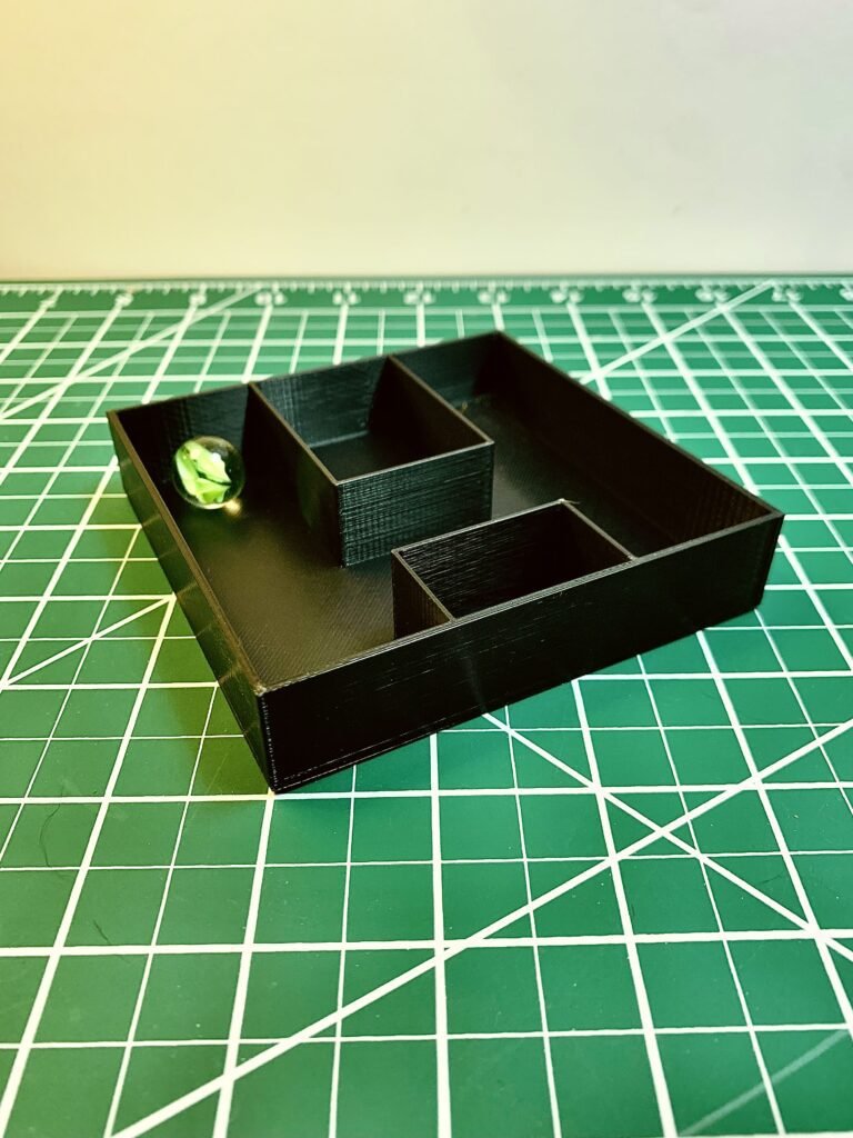 3D Printed Mystery box activity. It's 3D printed rectangular box with different fin designs on the inside and a marble. This one has two boxes inside it with a channel in the middle and 1 marble. 