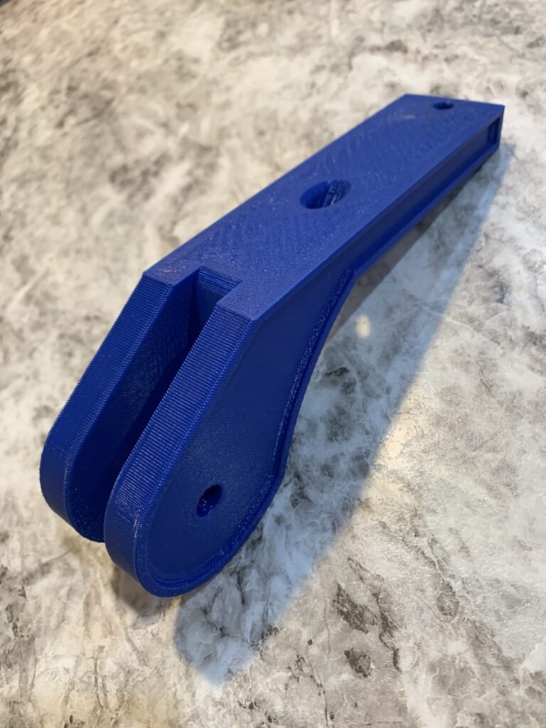 Created a skeg bracket that accommodates paracord to stow and deploy the skeg from the kayak while underway. 3D printed in blue. 