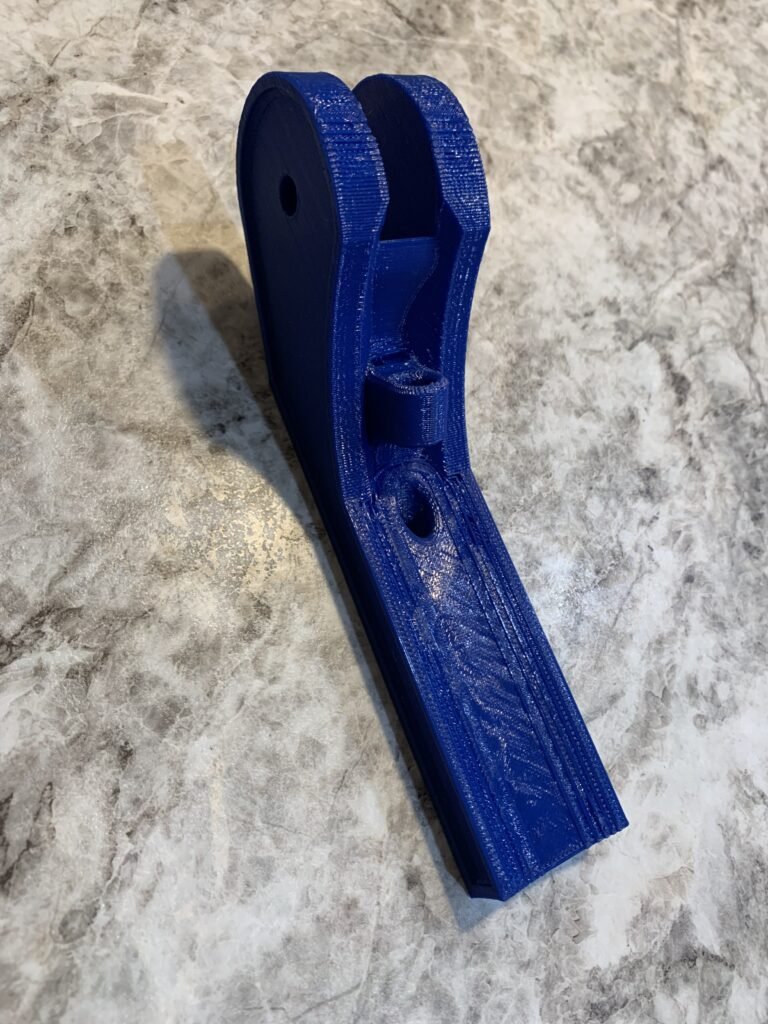 Created a skeg bracket that accommodates paracord to stow and deploy the skeg from the kayak while underway. 3D printed in blue. 