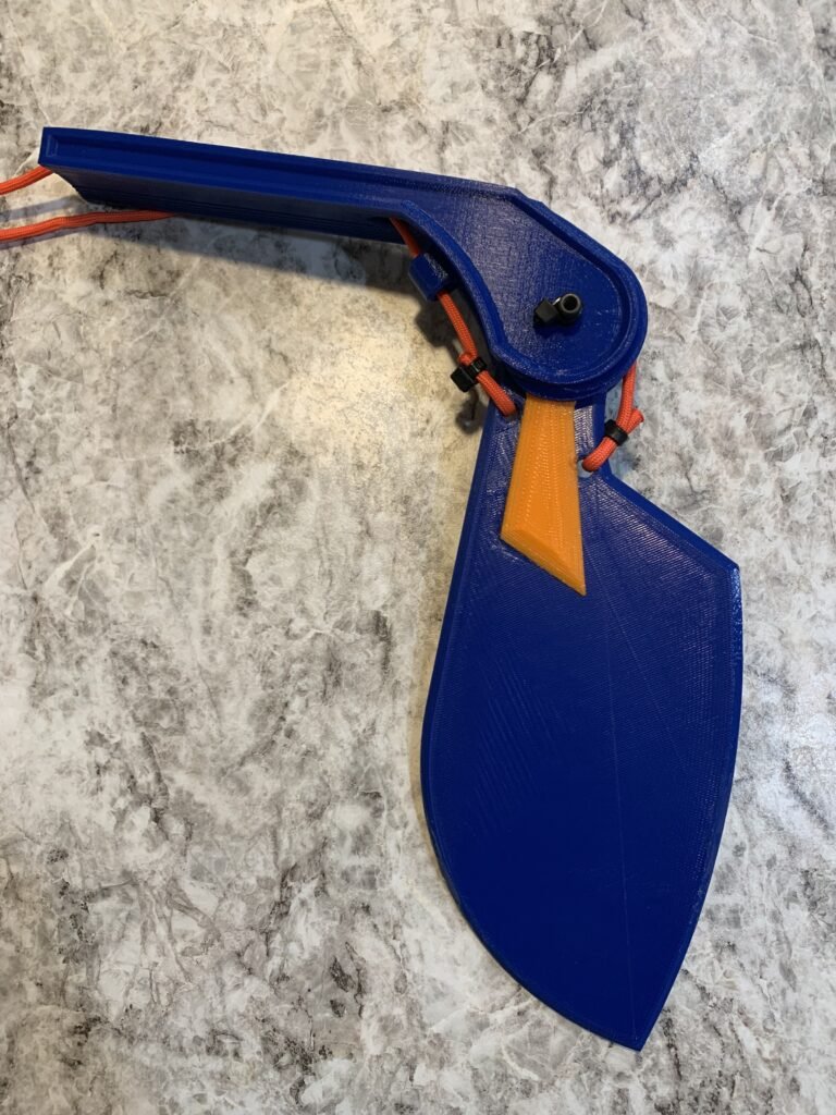 Created a skeg bracket that accommodates paracord to stow and deploy the skeg from the kayak while underway. 3D printed and assembled with skeg with orange paracord. 