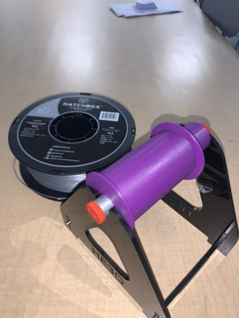 To reduce the rolling resistance of a full spool with the small axel, I created a universal fit adapter to fit every filament spool on this base's axel. Now it rolls easily. One thing to note: it was designed for manufacture, meaning I printed it in two parts the way I did to avoid supports and make it easy to use. Purple