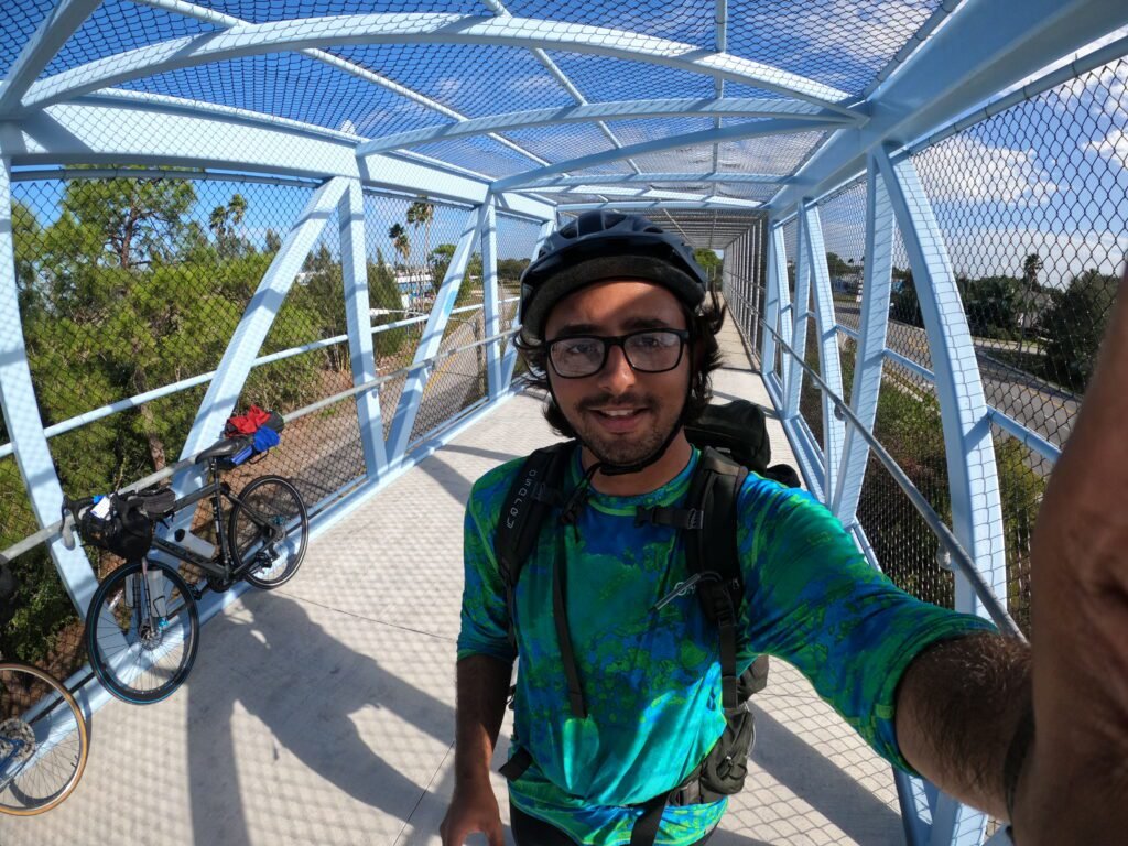 Biking across the state of Florida along the coast to coast trail. Taking a selfie on a bridge. 