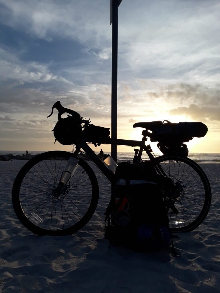 Biking across the state of Florida along the coast to coast trail. Made it to St. Petersburg. Bike and backpack leaning against sign post. 