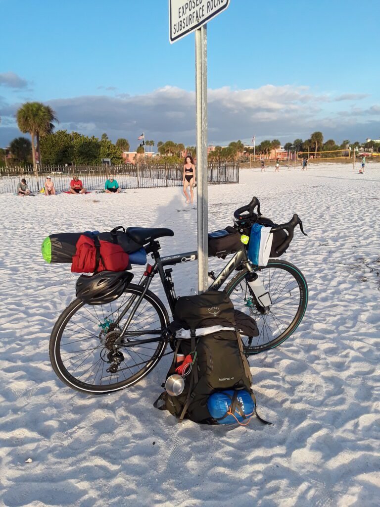 Biking across the state of Florida along the coast to coast trail. Made it to St. Petersburg. Bike and backpack leaning against sign post. 