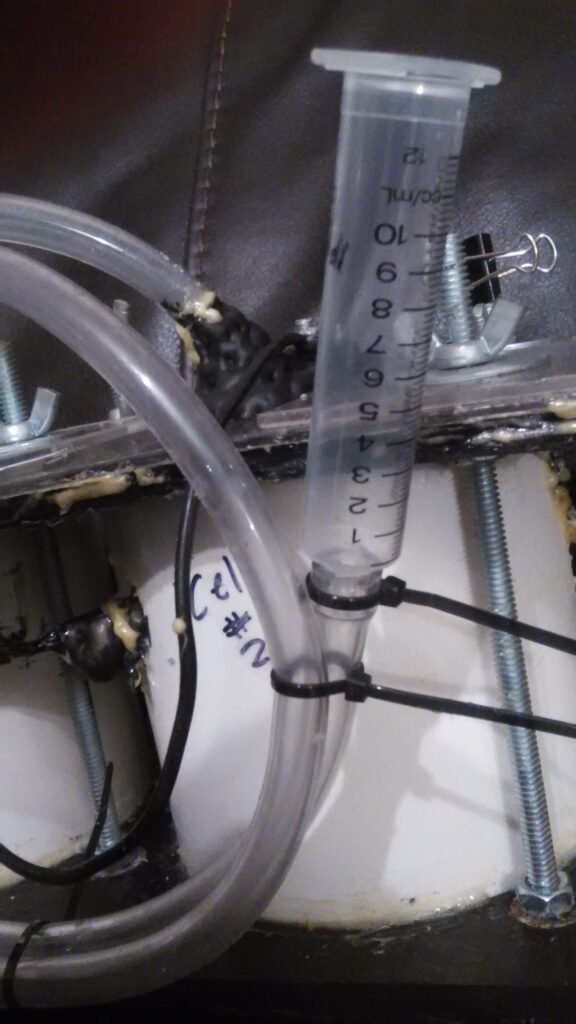 Electrolysis unit. A clever gas capture system - an inverted syringe filled with water. In a given period of time, I would measure the water volume displaced, which was equal to the amount of total gas achieved. With stoichiometry, the amount of hydrogen gas was found.