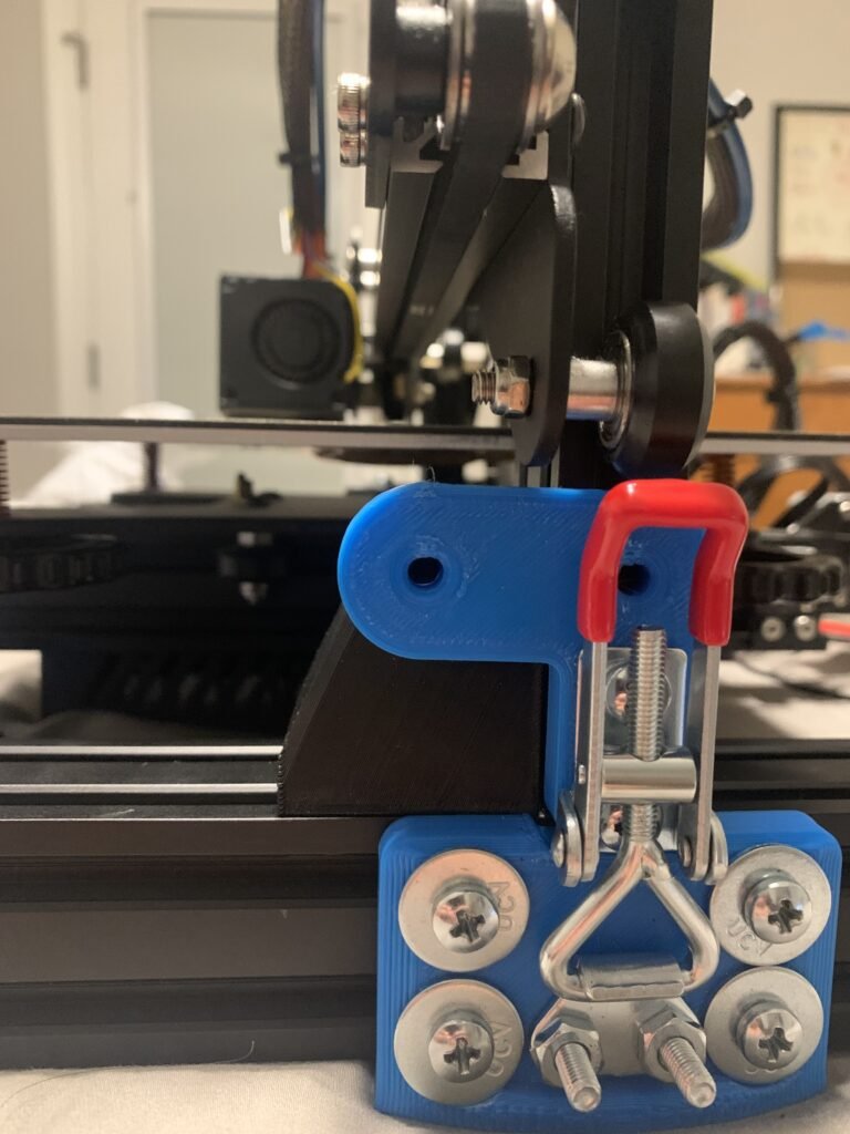 For my design, I opted for a toggle clamp to connect the top and bottom sections of the printer. Two side brackets were made to attach the sections together. This solution offers a fast and highly secure method for aligning the two portions effectively. My approach aims to reduce reliance on off-the-shelf components by incorporating more 3D-printed parts.