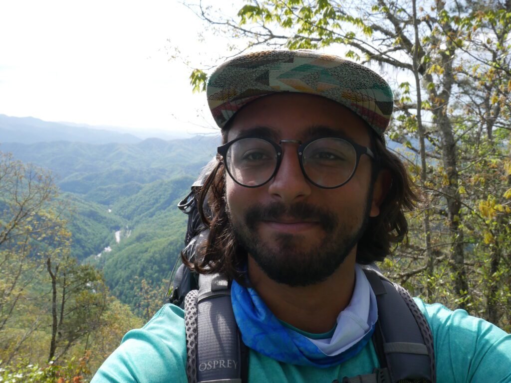 Hiking the Appalachian Trail. With a picture of me over the edge of mountainside. Mario Sultan