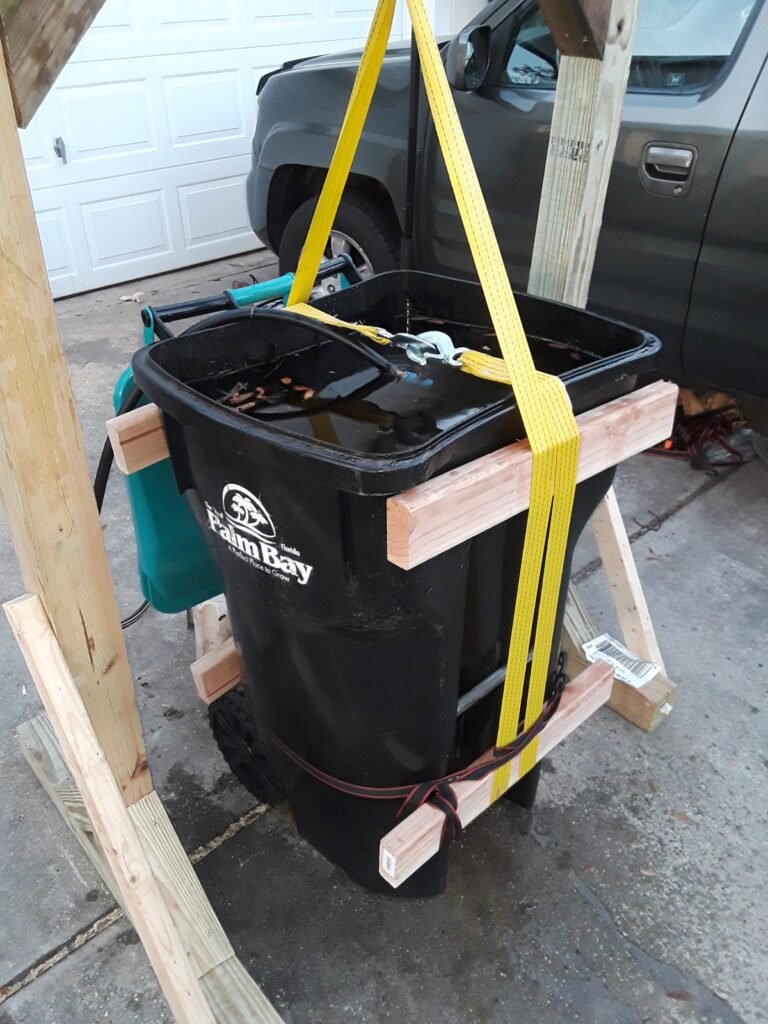 Wooden hoist, attached to it a worm winch and a trash can with 500 lbs. of water based on the volume added to it. I was able to confirm our two design questions.