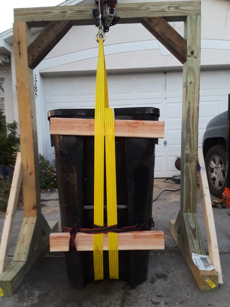 Wooden hoist, attached to it a worm winch and a trash can with 500 lbs. of water based on the volume added to it. I was able to confirm our two design questions.