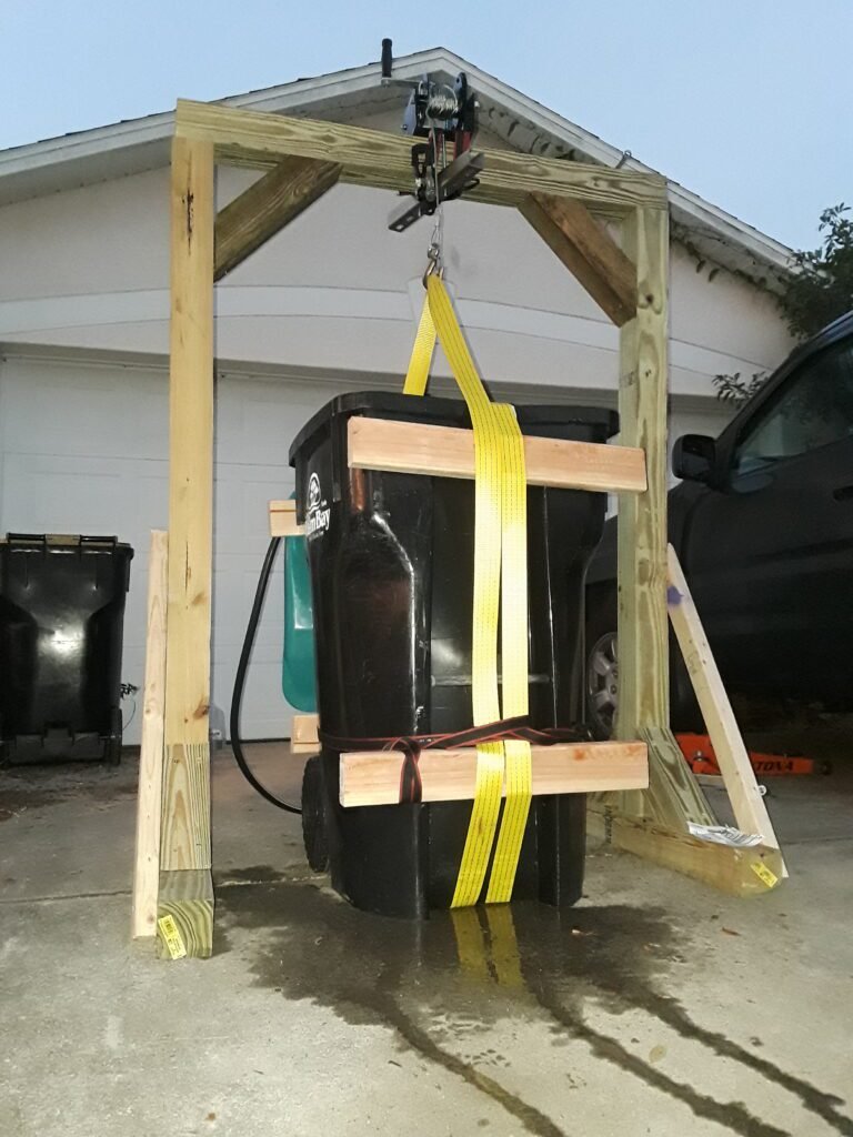 Wooden hoist, attached to it a worm winch and a trash can with 500 lbs. of water based on the volume added to it. I was able to confirm our two design questions.