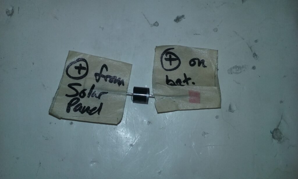 Solar panel outside voltage output test with multimeter. Using a diode in the solar panel relay. Labeled for proper assembly. 
