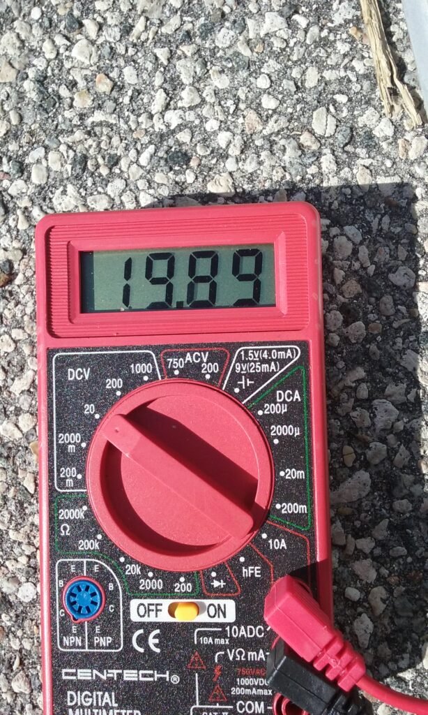 Solar panel outside voltage output test with multimeter. 19 volts.