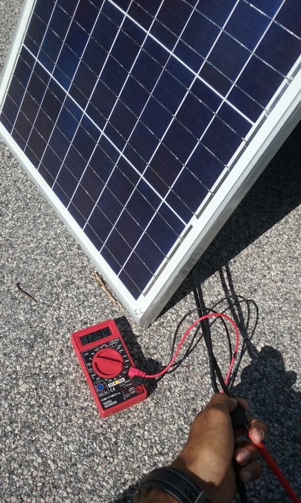 Solar panel outside voltage output test with multimeter.