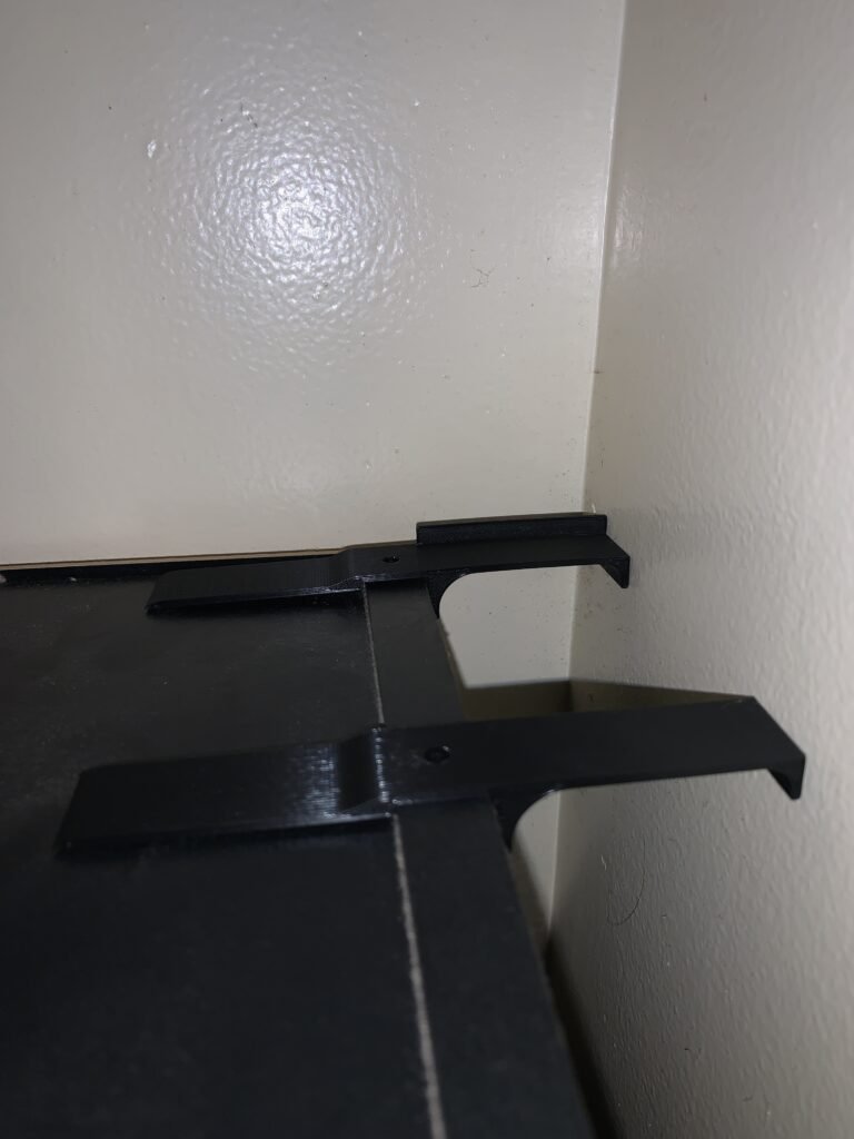 Solving the pesky bookshelf gap! A custom-designed bracket keeps books upright and secure, combining function and style. 3D printed bracket. 