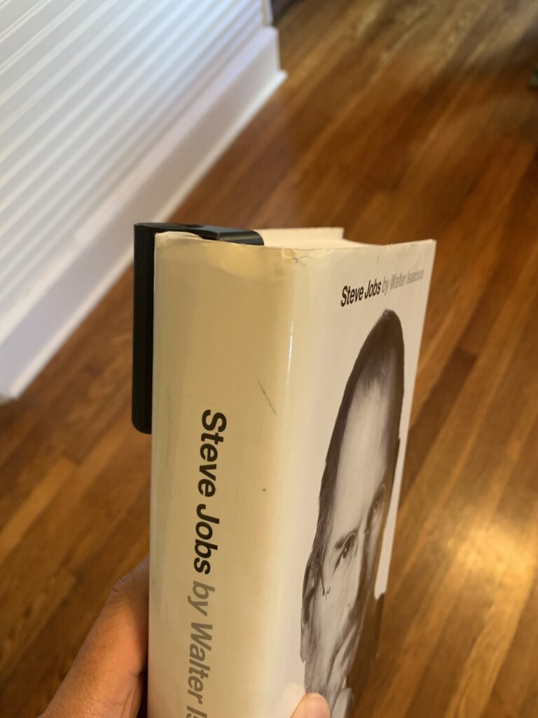You’re probably wondering…why not simply clip your pen or highlighter to your book? If you’re anyone like me, you write a lot in a book and you prefer to read, when standing or sitting on the couch, or even on the toilet. So instead of setting my pen down on my chest or my ear, I designed an printed a holder that clips into any book and hold a pen and highlighter. 3D Printed Book Pen Holder with Steve Jobs by Walter Isaacson's book
