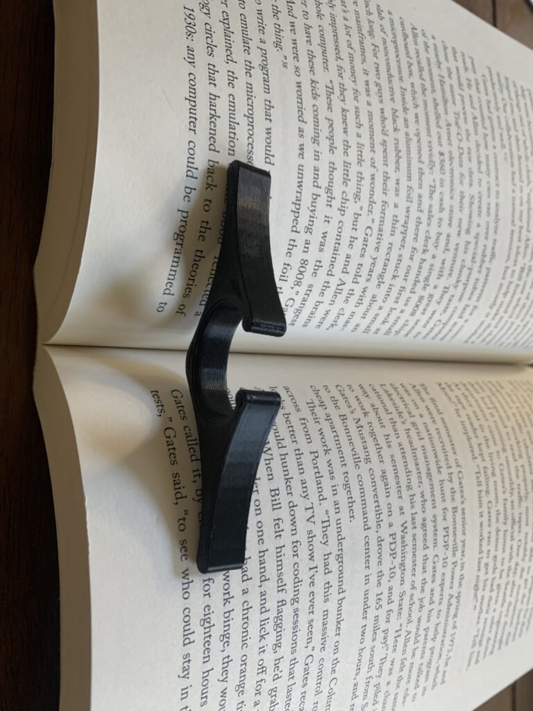 Thumb book page holder, black, modern, curvy. 3D printed