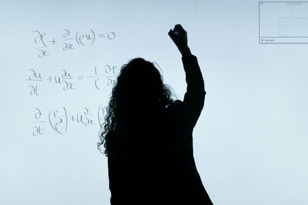 Female aerospace engineer writes equations https://unsplash.com/photos/woman-in-black-long-sleeve-shirt-GzDrm7SYQ0g